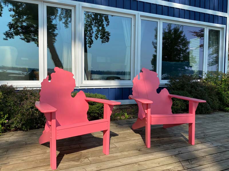 two wooden chairs with the back carved as the state of Michigan