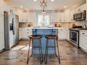 Modern farmhouse kitchen project with blue island and white cabinets.